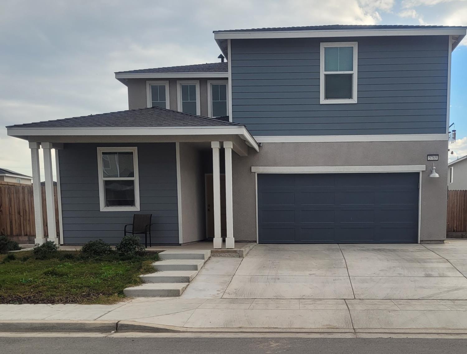 5769 West Austin Way Fresno, CA 93722 - Photo 2 of 32 a front view of a house