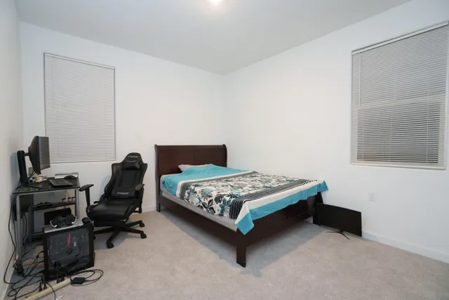 a bedroom with a bed and a desk