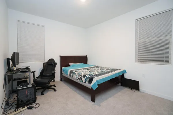 a bedroom with a bed and a desk