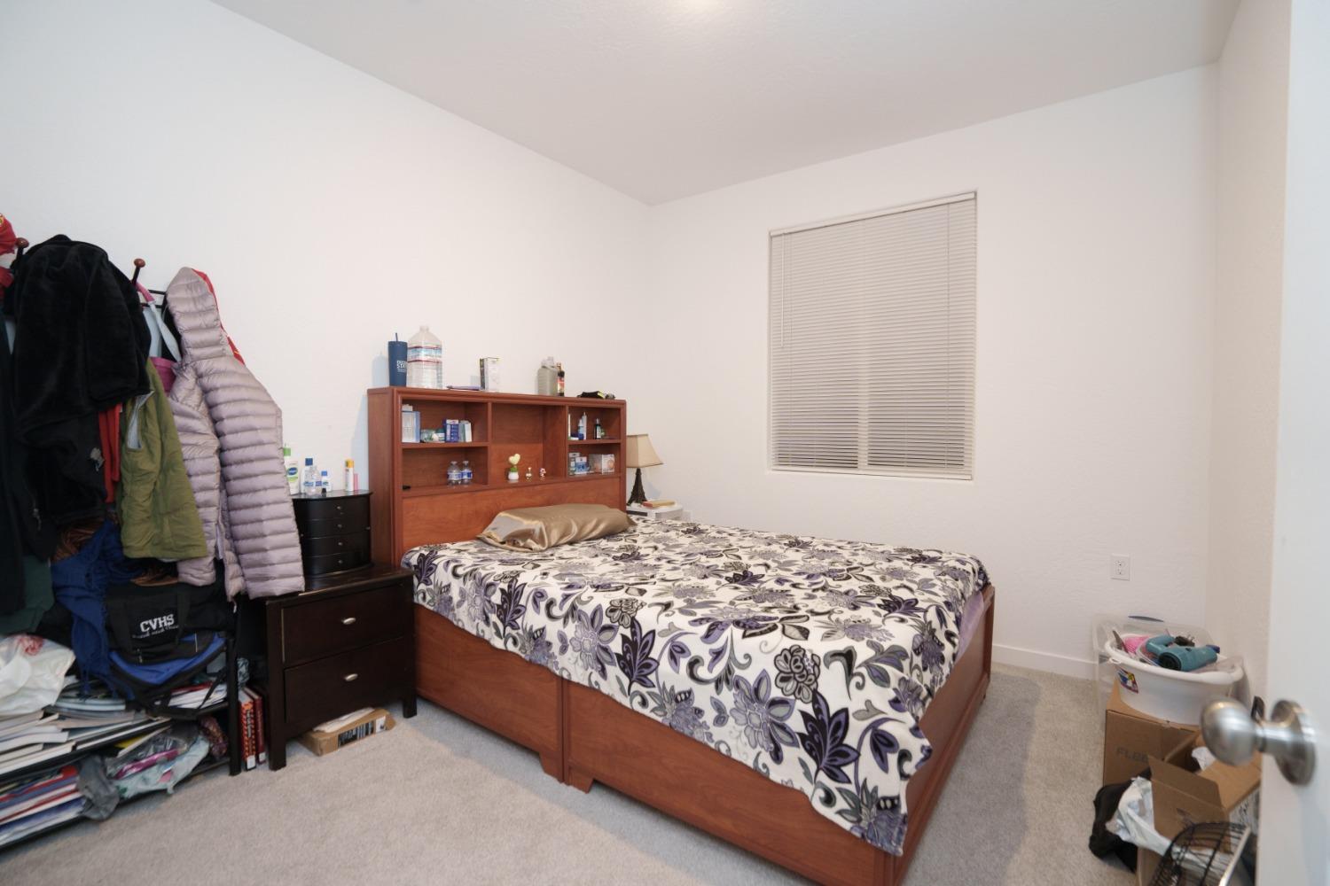 5769 West Austin Way Fresno, CA 93722 - Photo 24 of 32 a bedroom with a bed and a closet
