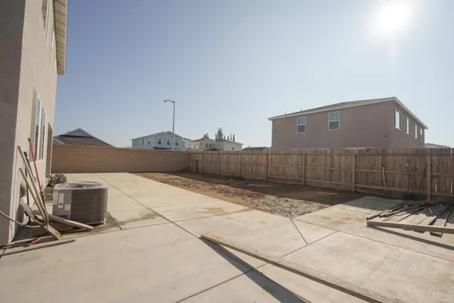 a front view of a house with yard and seating space