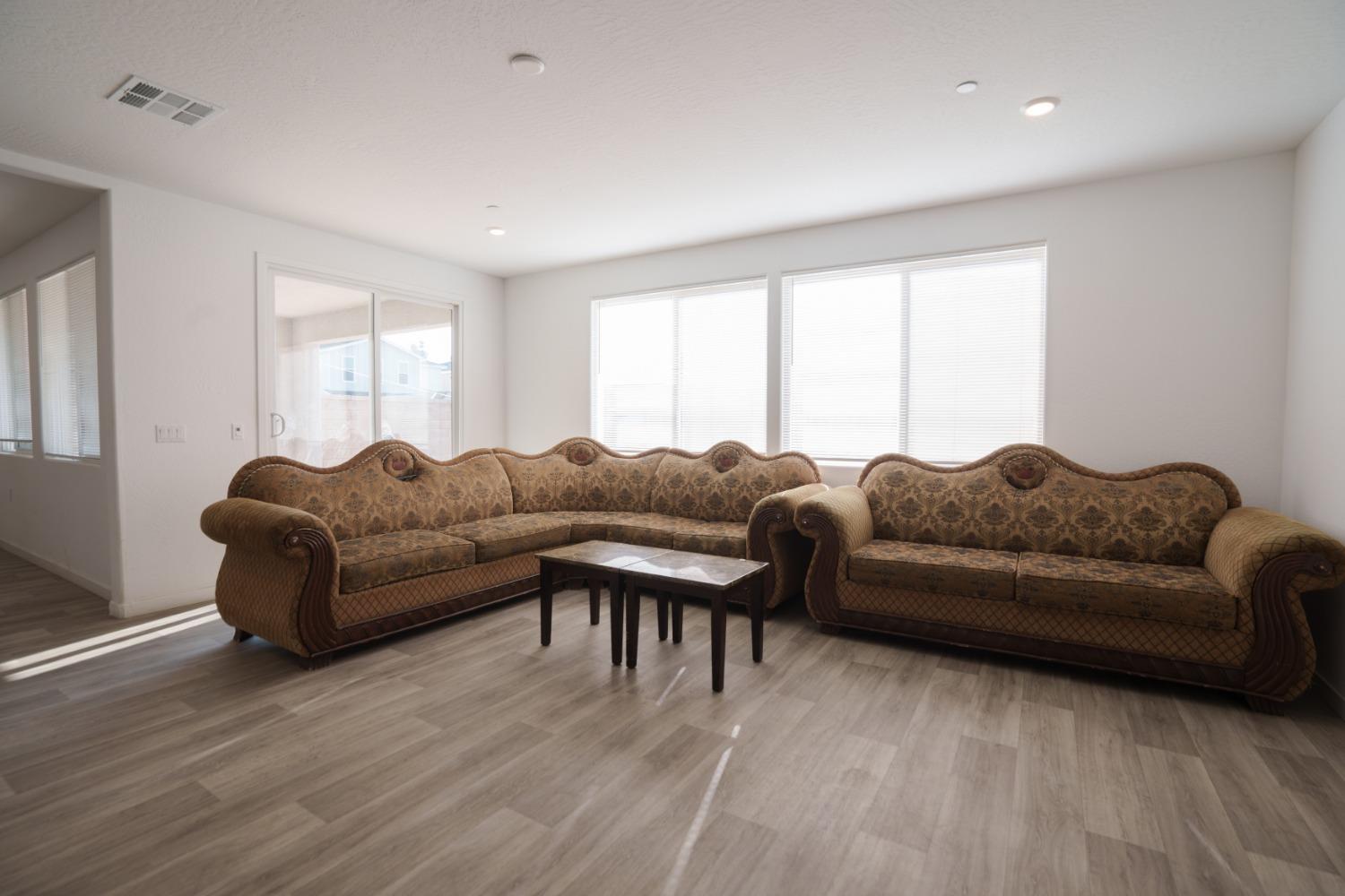 5769 West Austin Way Fresno, CA 93722 - Photo 5 of 32 a living room with a couch and a window