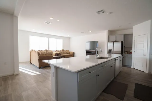 a kitchen with stainless steel appliances a sink and a refrigerator