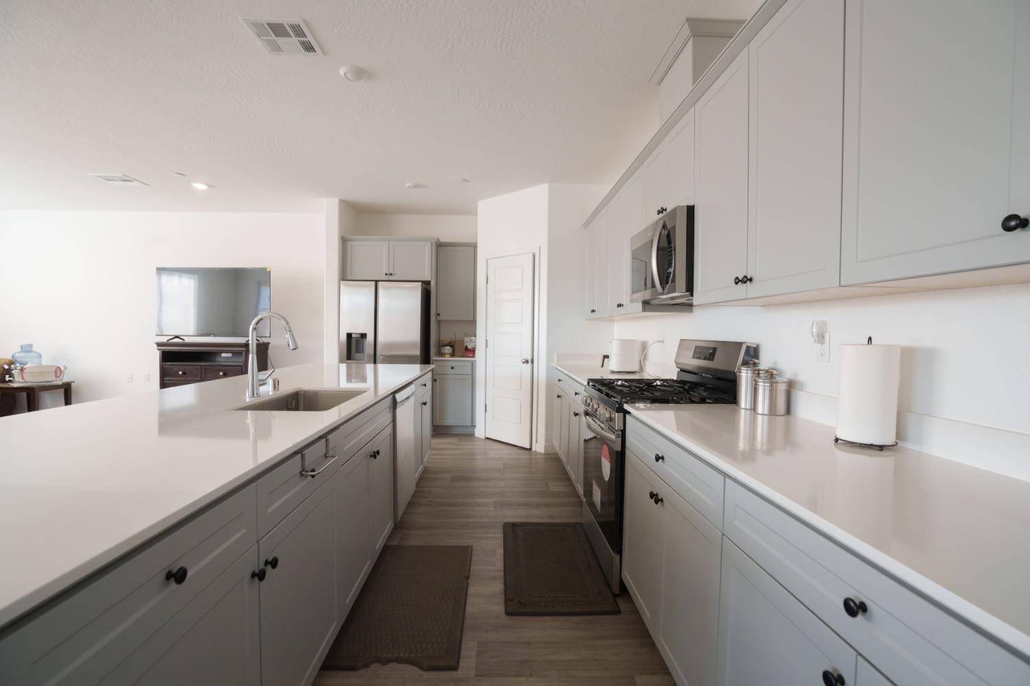 5769 West Austin Way Fresno, CA 93722 - Photo 8 of 32 a large kitchen with stainless steel appliances lots of counter space sink and cabinets