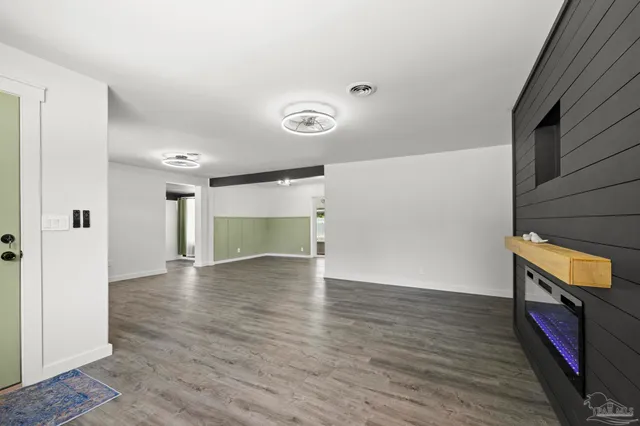 a view of a kitchen with furniture and wooden floor