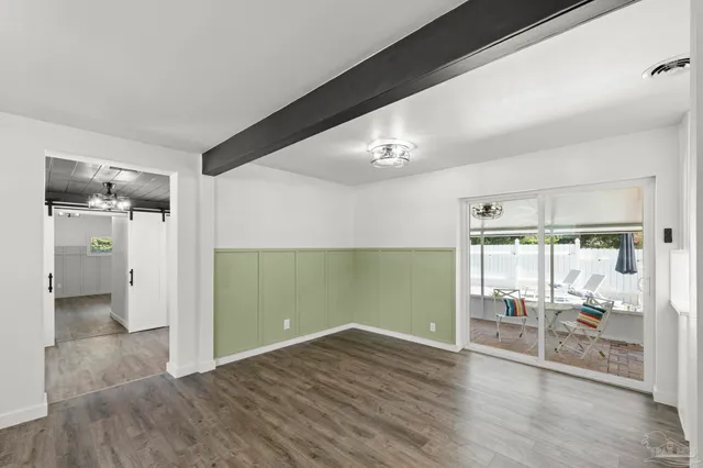 a kitchen with a refrigerator sink and white cabinets