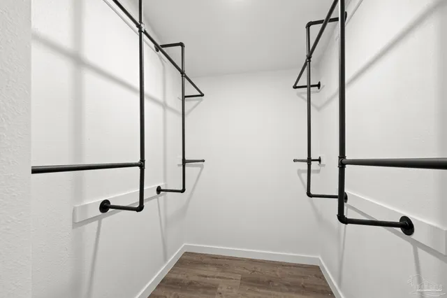 an empty room with windows and a fireplace