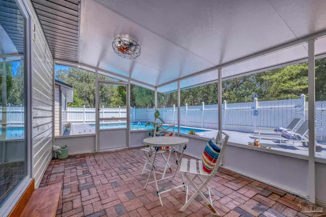 a view of a house with backyard and sitting area