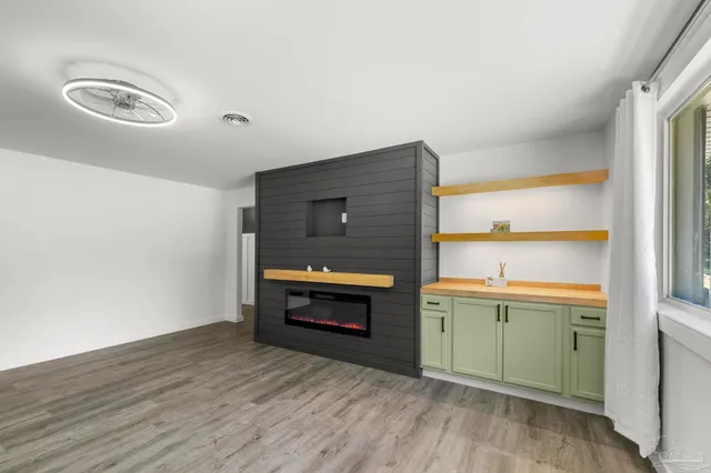 a view of empty room with wooden floor