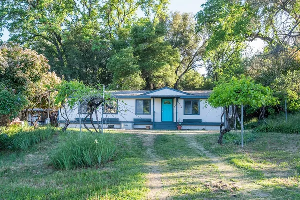 a backyard of a house with table and chairs