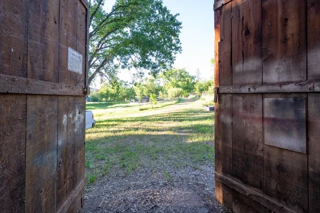 a backyard of a house with lots of green space and a fountain
