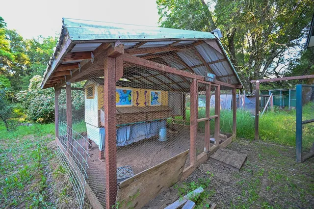 a kitchen with a sink a wooden floor and a large window