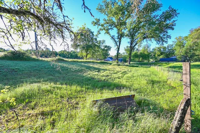 a open kitchen with a wooden floor and electronic appliances