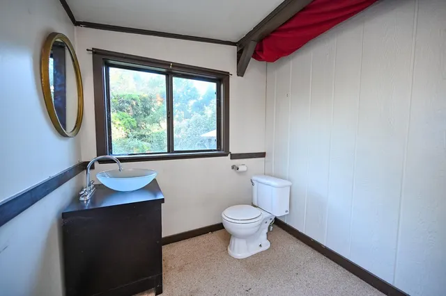 a view of a room with wooden floor and furniture