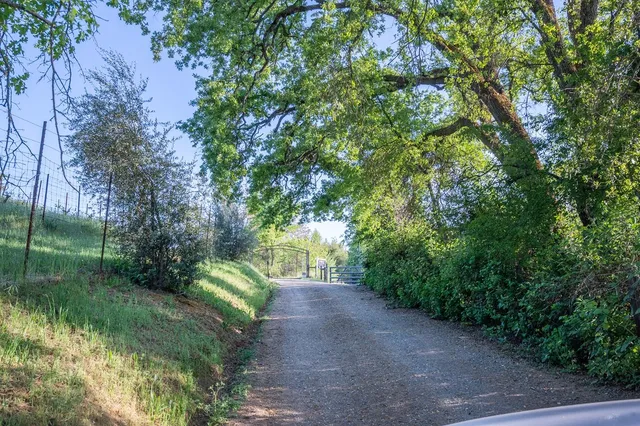 a backyard of a house with barbeque oven and outdoor seating