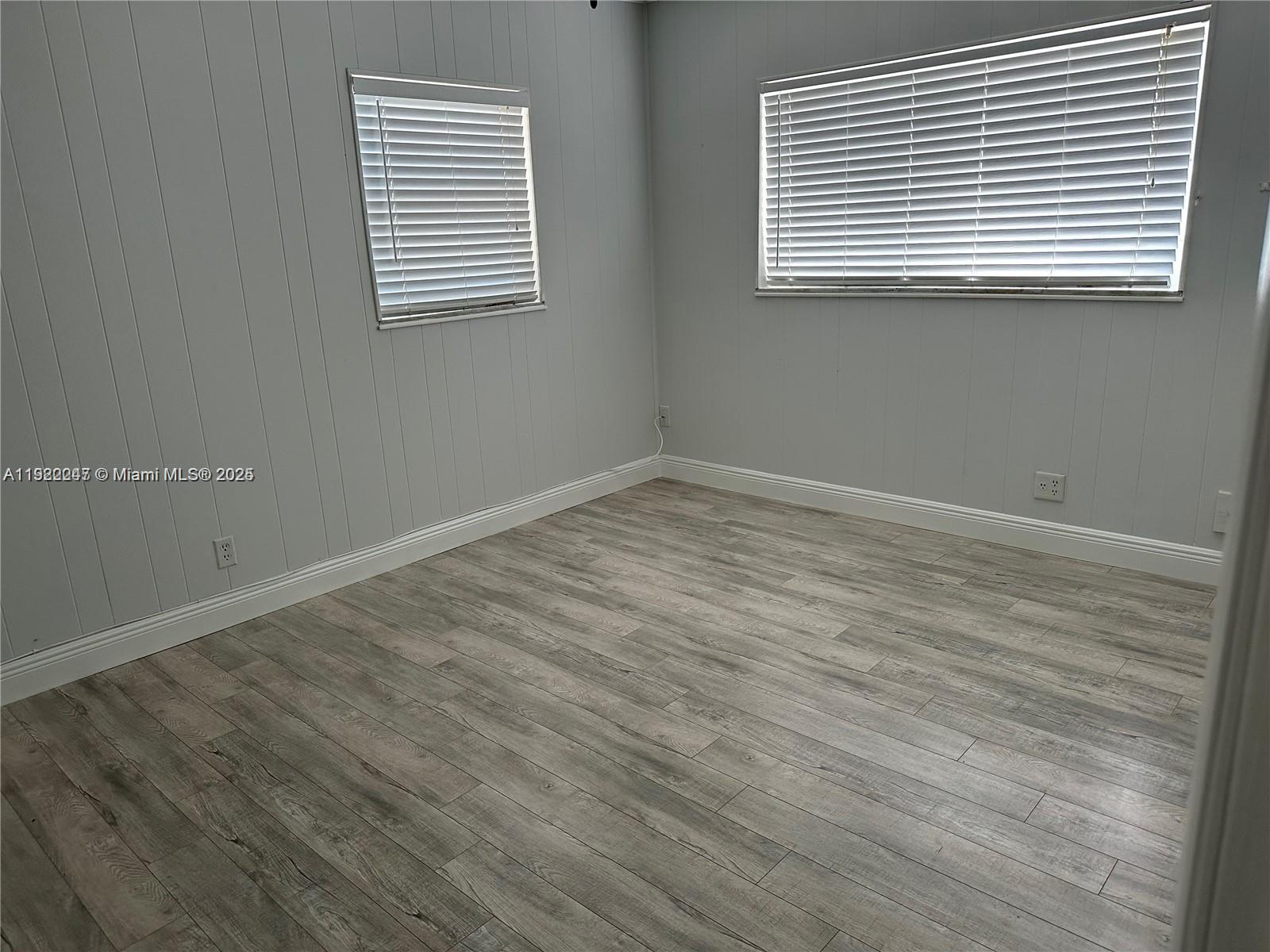 141 Northeast 10th Avenue, Unit 18B Hallandale Beach, FL 33009 - Photo 11 of 15 an empty room with wooden floor
