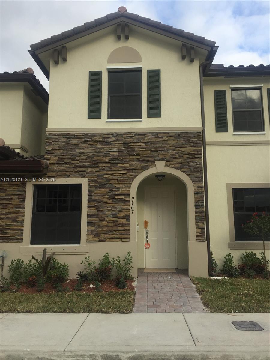 9307 West 33rd Way Hialeah, FL 33018 - Photo 2 of 23 a front view of a house with yard