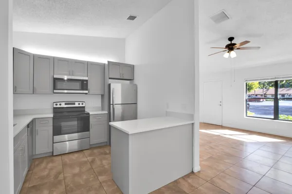 a kitchen with granite countertop a refrigerator and a stove