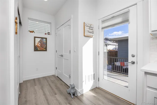 a view of a hallway with wooden floor and closet
