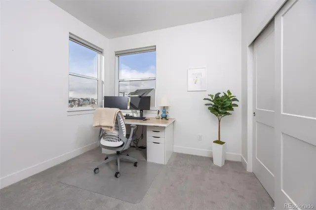 a workspace with furniture and a potted plant