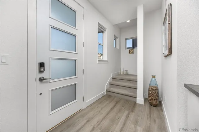 a view of an entryway with wooden floor