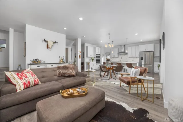 a living room with furniture and kitchen view