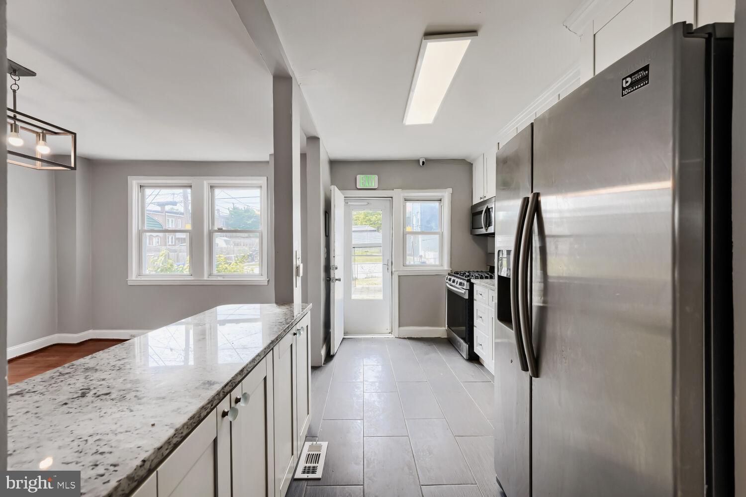 1014 Lyndhurst Street Baltimore, MD 21229 - Photo 10 of 29 a view of a kitchen with a sink refrigerator and window
