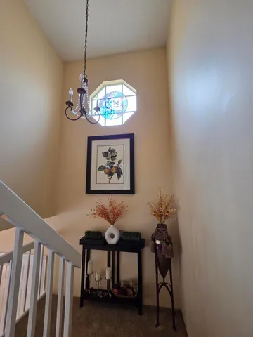 a view of a dining room with a table and chairs