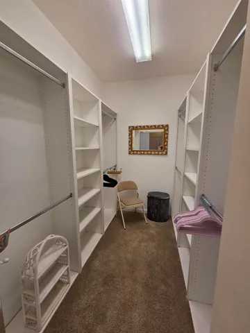 a bedroom with a bed and cabinets