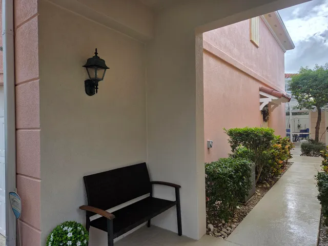 a backyard of a house with wooden floor and outdoor seating