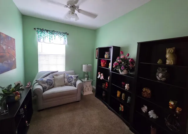 a living room with furniture a window and a flat screen tv