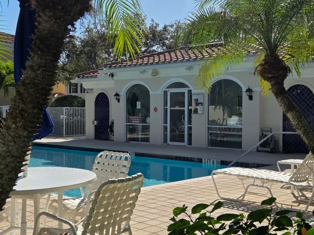 a sign that is sitting in front of a tree