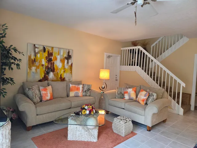 a living room with furniture and stairs