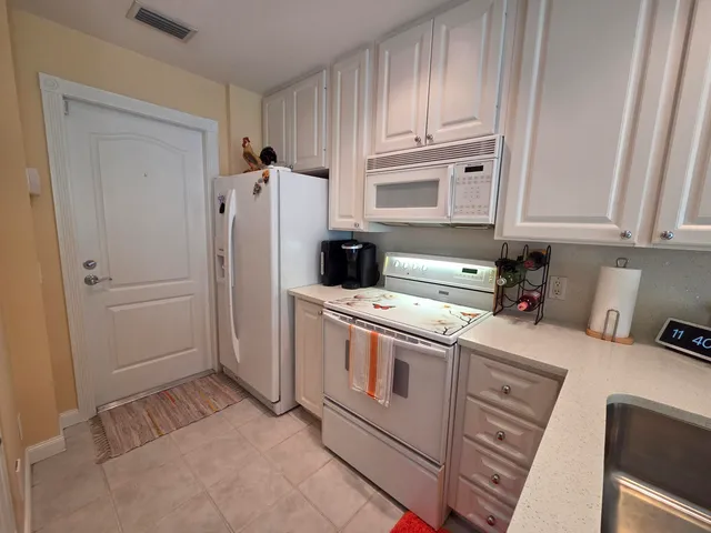 a kitchen with a refrigerator stove and cabinets