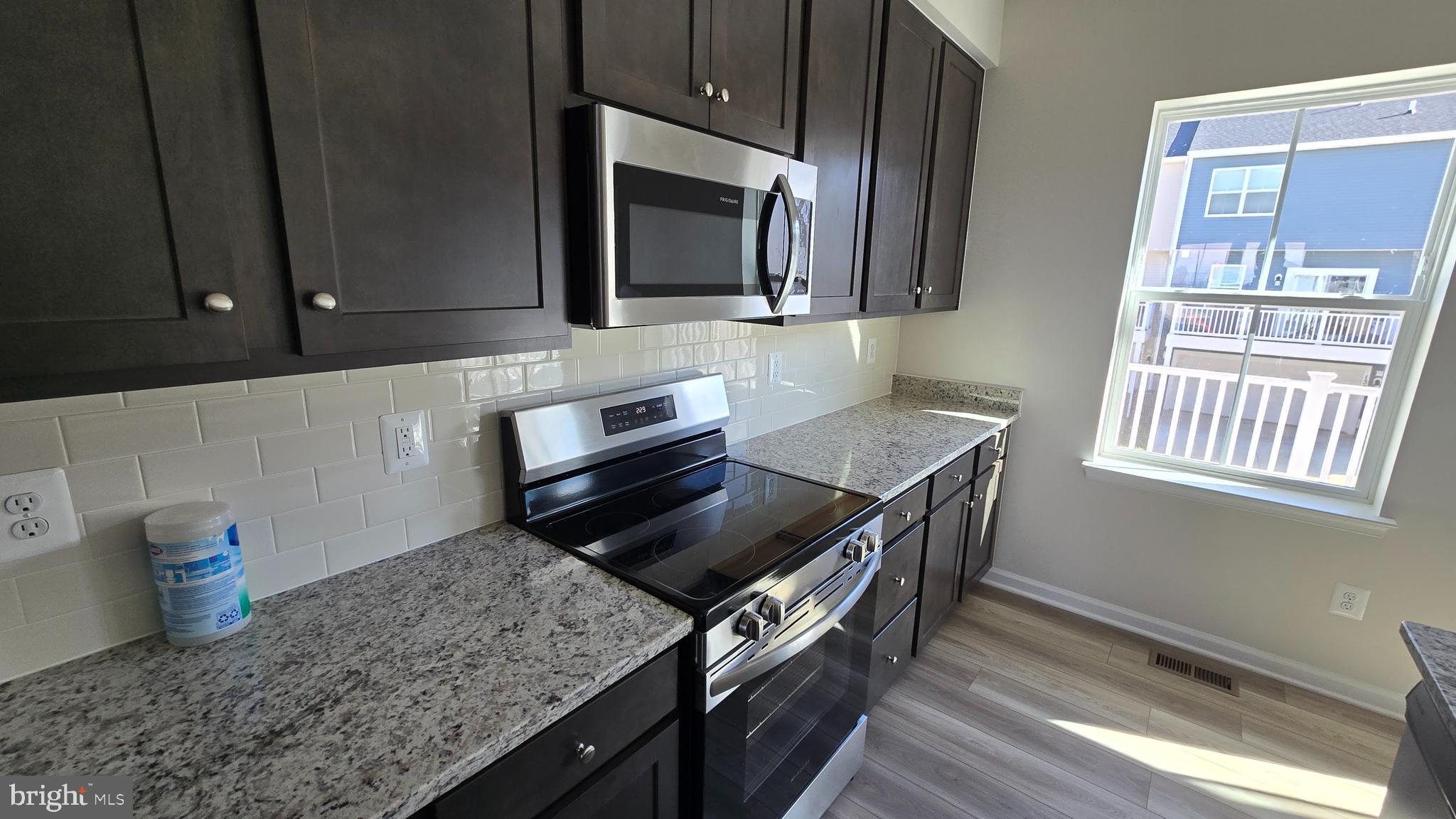 1344 Red Clover Lane Ranson, WV 25438 - Photo 17 of 31 a kitchen with a stove and a microwave