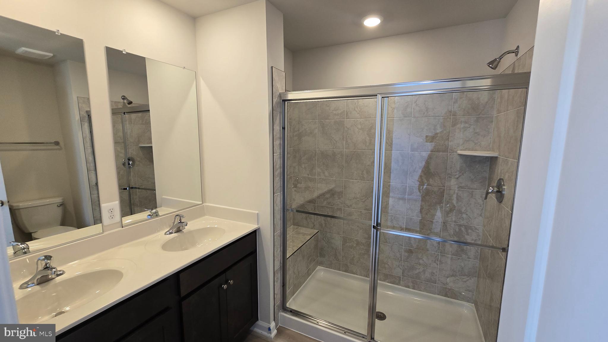1344 Red Clover Lane Ranson, WV 25438 - Photo 22 of 31 a bathroom with a shower sink and mirror