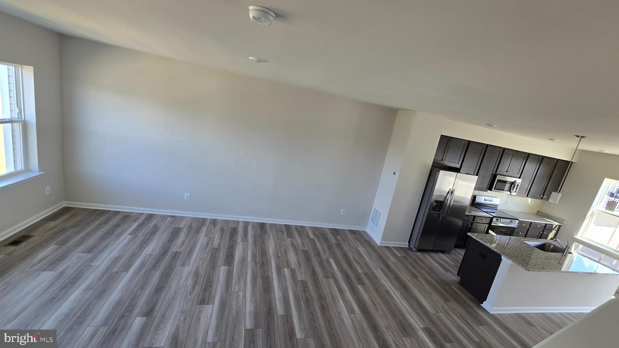 1344 Red Clover Lane Ranson, WV 25438 - Photo 30 of 31 a view of a room with wooden floor and electronic appliances
