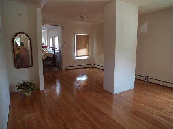 wooden floor in a hall with a window