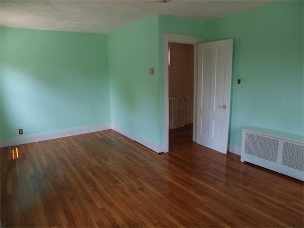 39 Avon Street Somerville, MA 02143 - Photo 11 of 16 an empty room with wooden floor and closet