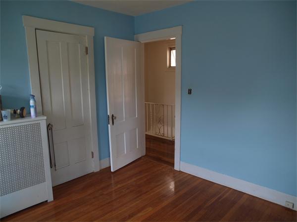 39 Avon Street Somerville, MA 02143 - Photo 15 of 16 a view of an empty room with wooden floor and closet