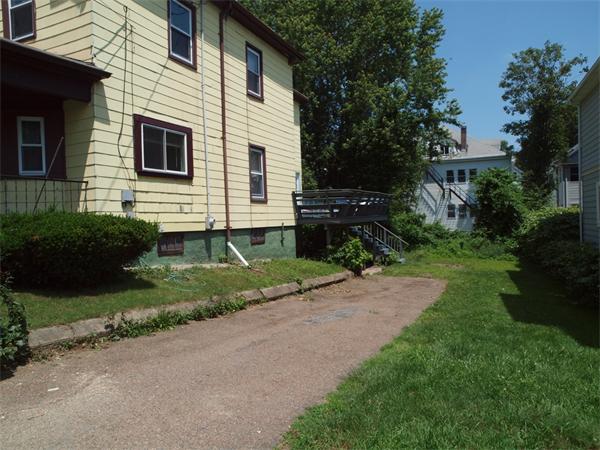 39 Avon Street Somerville, MA 02143 - Photo 2 of 16 a front view of a house with a yard and outdoor seating