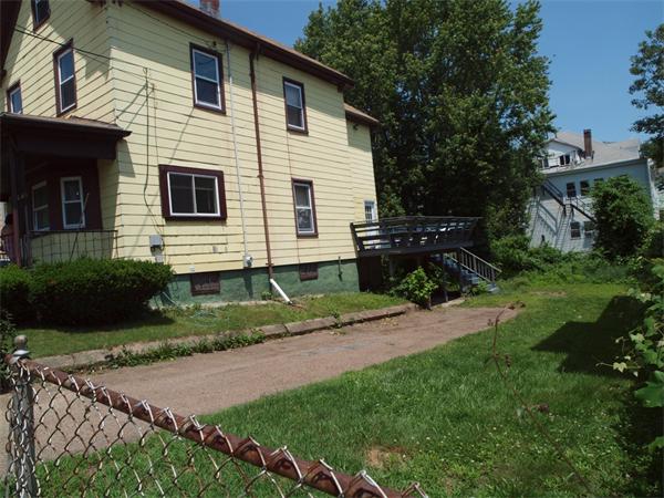 39 Avon Street Somerville, MA 02143 - Photo 3 of 16 a front view of a house with a yard and potted plants