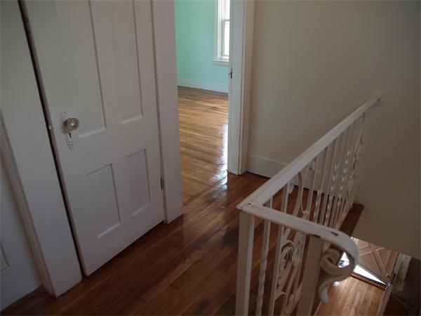 39 Avon Street Somerville, MA 02143 - Photo 7 of 16 a view of a hallway with wooden floor and entryway