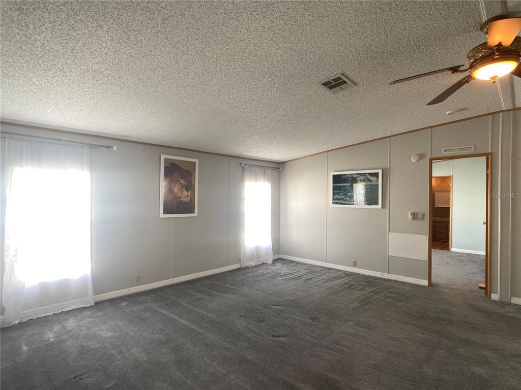 1710 7th Street Southwest, Unit 85 Ruskin, FL 33570 - Photo 11 of 28 an empty room with windows and closet