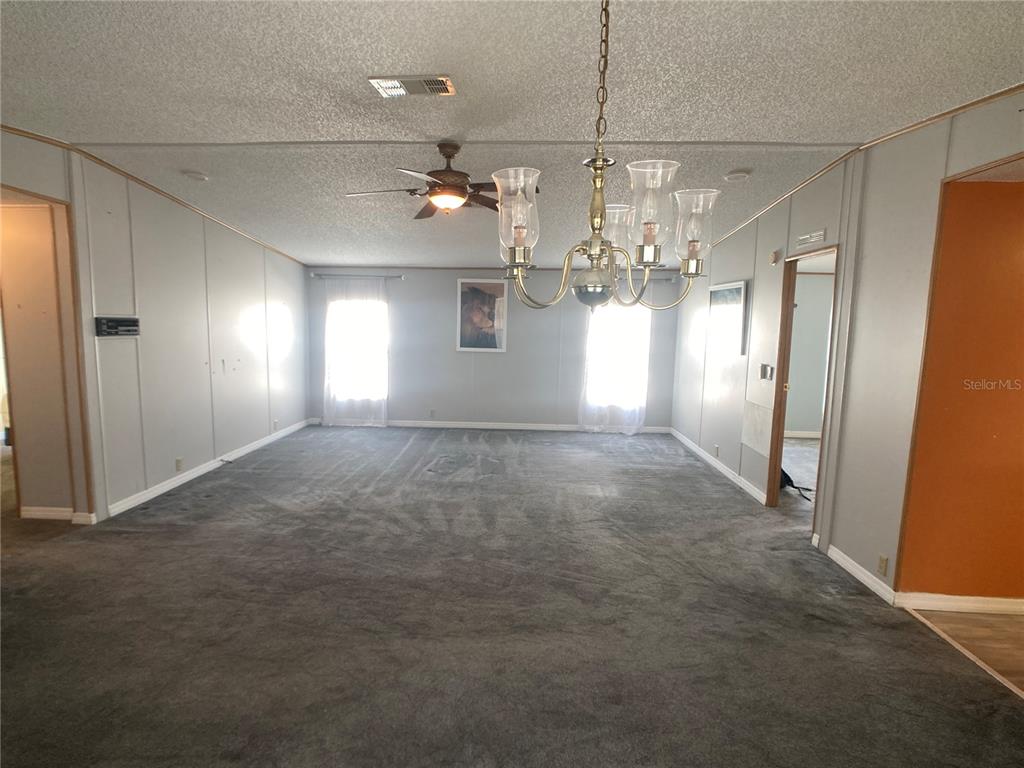 1710 7th Street Southwest, Unit 85 Ruskin, FL 33570 - Photo 14 of 28 an empty room with windows and ceiling fan