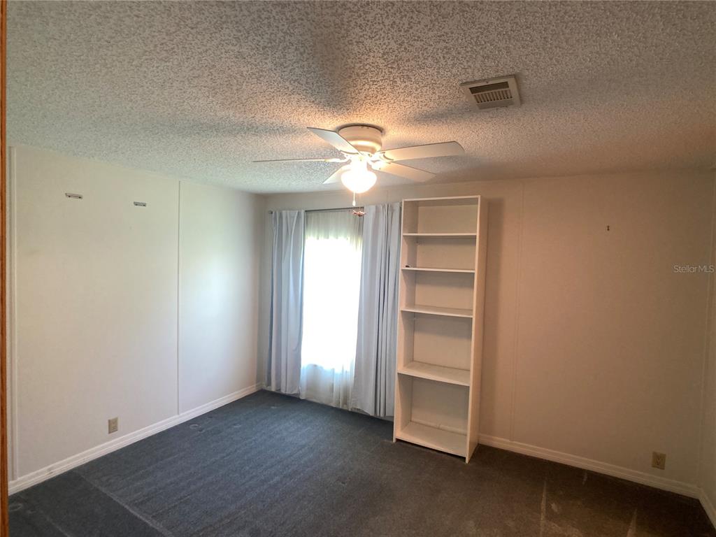1710 7th Street Southwest, Unit 85 Ruskin, FL 33570 - Photo 21 of 28 a view of an empty room with a ceiling fan