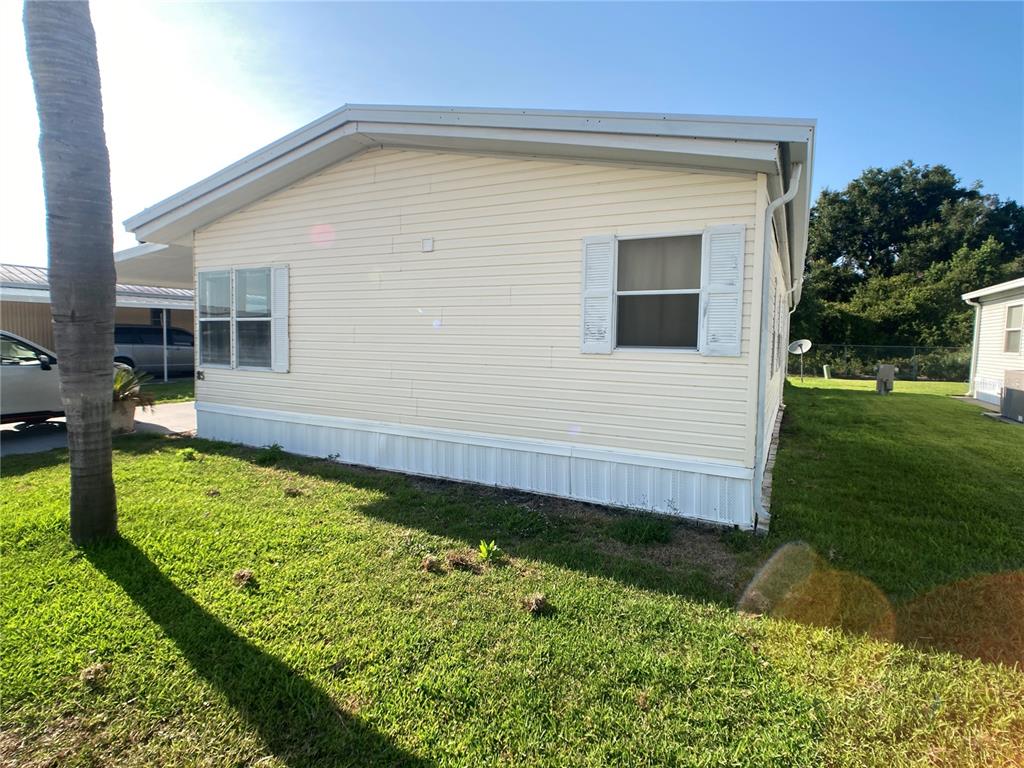 1710 7th Street Southwest, Unit 85 Ruskin, FL 33570 - Photo 25 of 28 a front view of a house with garden