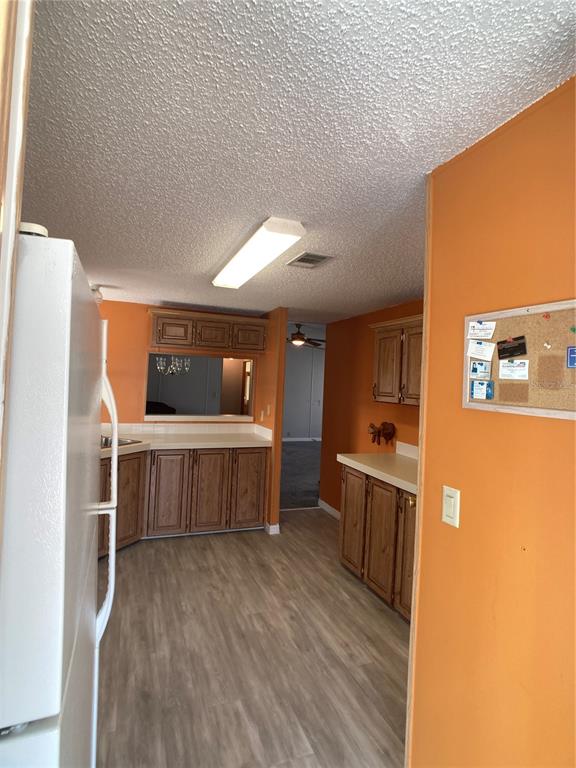 1710 7th Street Southwest, Unit 85 Ruskin, FL 33570 - Photo 9 of 28 a kitchen with a refrigerator and a stove top oven