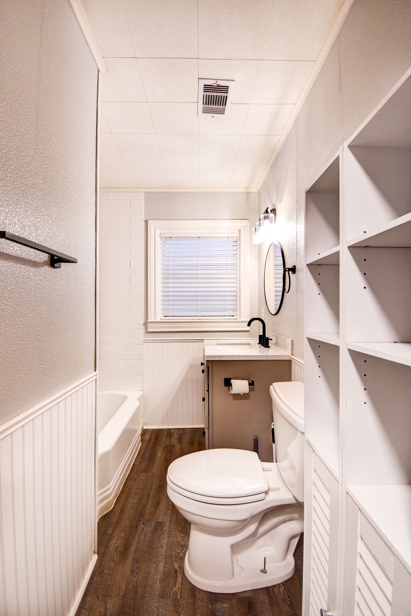 808 Akers Street Angleton, TX 77515 - Photo 5 of 11 a bathroom with a toilet sink a mirror a vanity and shower