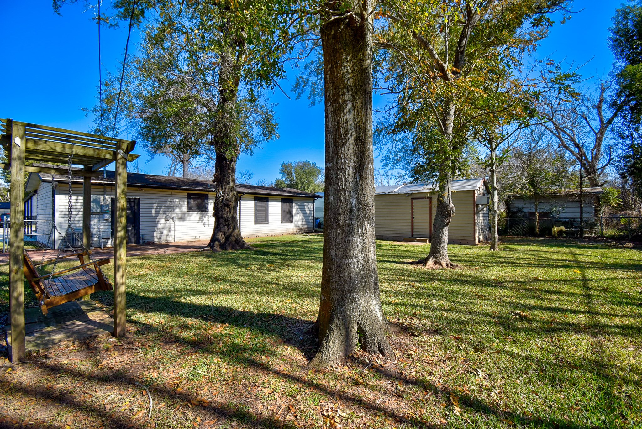 808 Akers Street Angleton, TX 77515 - Photo 10 of 11 a view of a house with a yard fire pit and a large tree